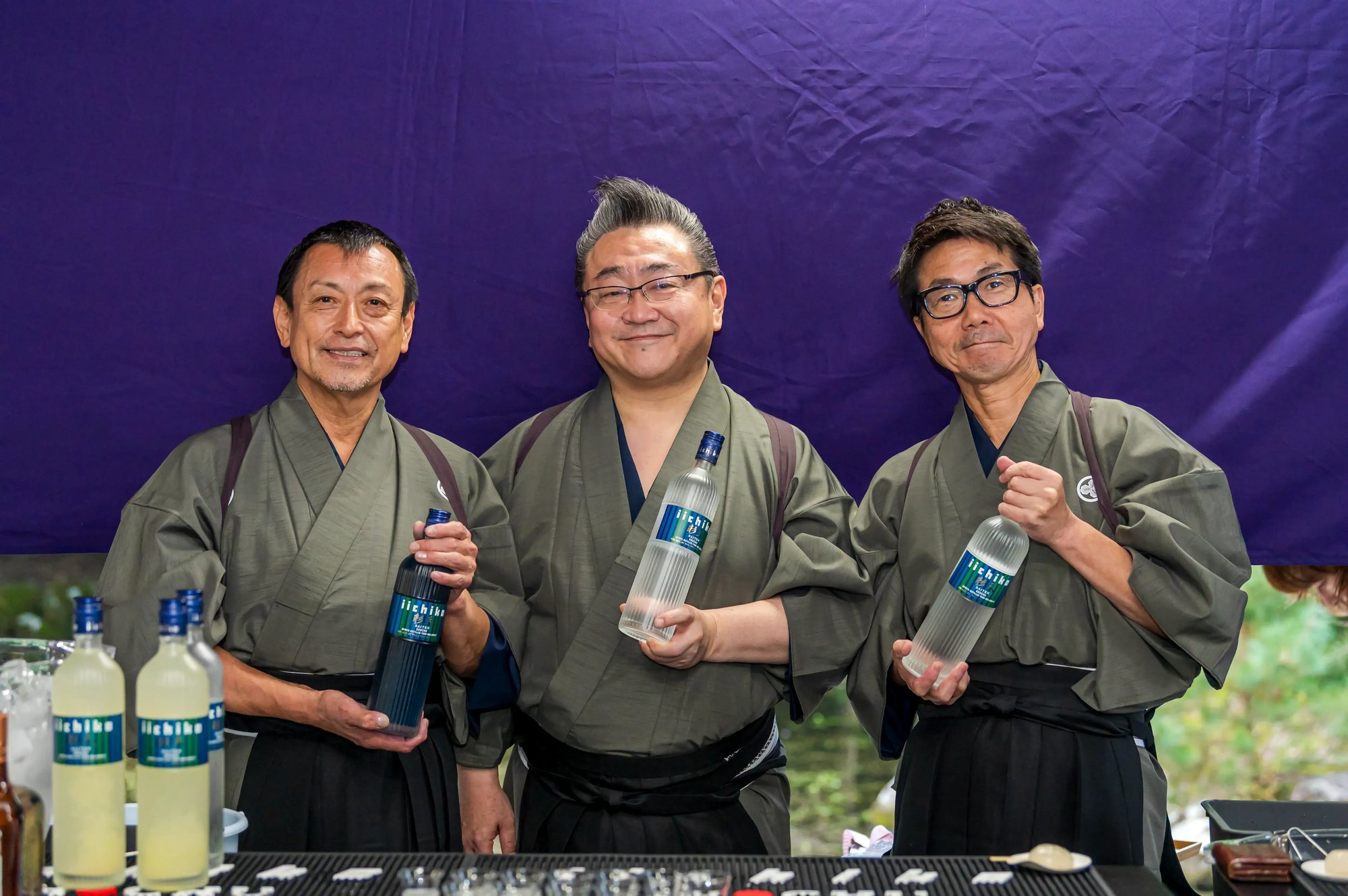 Three guest bartenders holding iichiko Saiten
