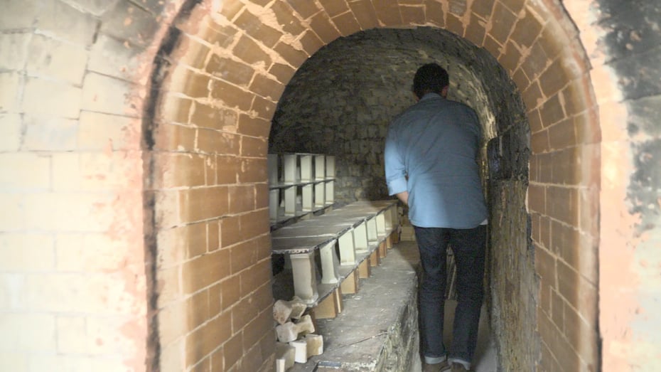 登り窯の焼成室の内部を見学する後藤さん