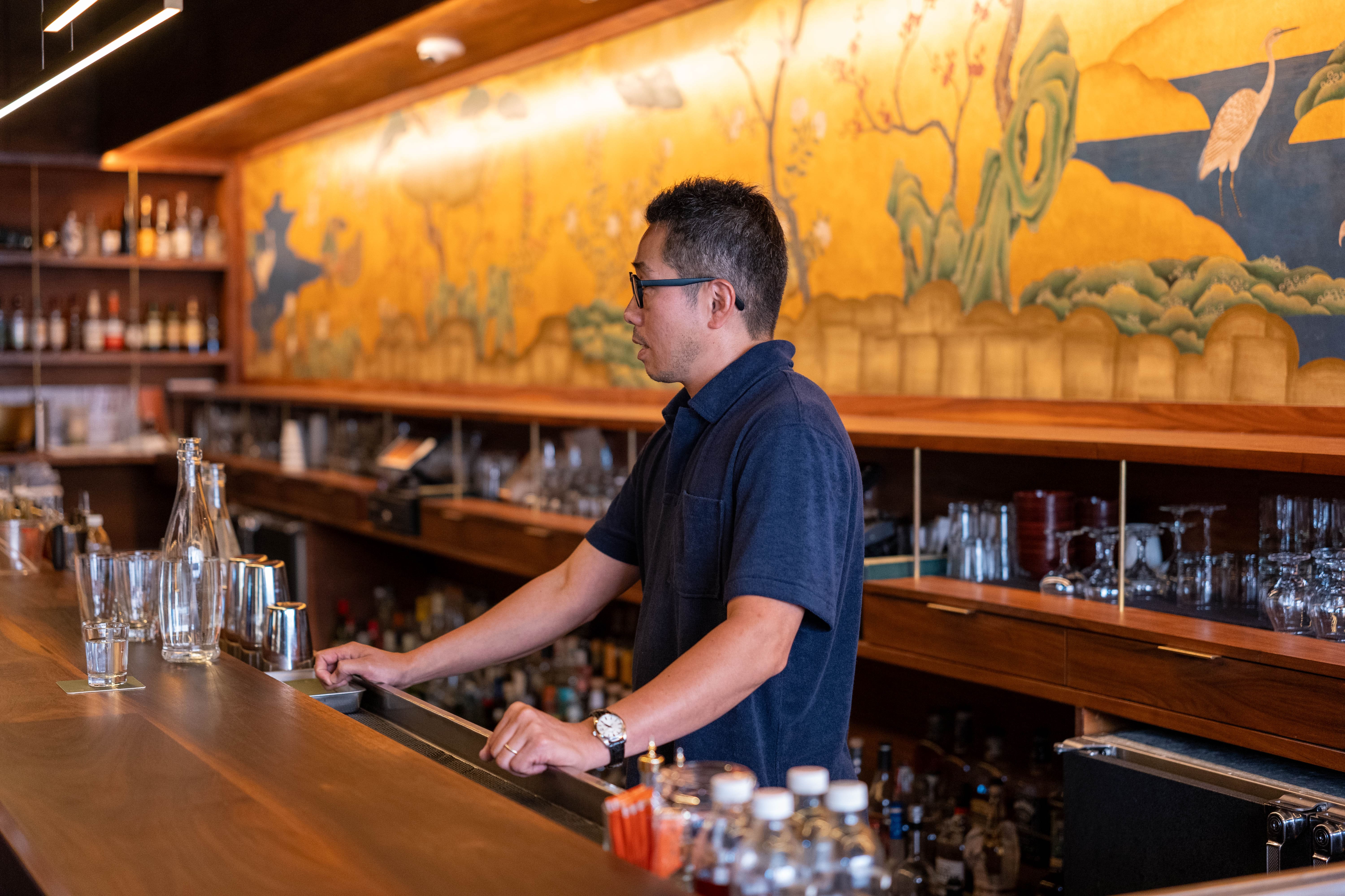 Bar Goto Niban. A golden Japanese painting hangs behind the bar counter, producing a stylish Japanese ambience.