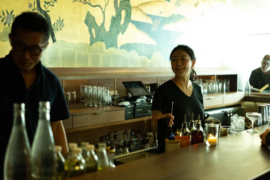 Bar Goto Niban’s head bartender, Koharu Usui (right), holds a stirrer behind the bar. She's a leader Mr. Goto relies on to keep the establishment running smoothly.